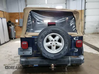 2000 Jeep Wrangler SE with VIN 1J4FA29P1YP739555, listed as a Copart auction lot 58501025 with 128,458 mi miles and Clean title. Bid and sale history available at DreamBid. Image 6.