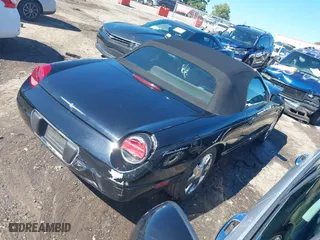 2002 Ford Thunderbird w/Hardtop Premium with VIN 1FAHP60AX2Y116200, listed as a IAAI auction lot 40129557 with 88,991 mi miles. Bid and sale history available at carsss.com. Image 4.