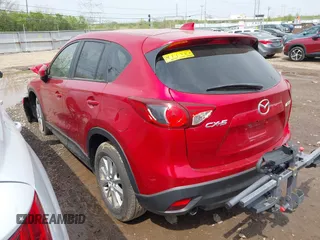 2014 Mazda CX-5 Touring with VIN JM3KE2CY4E0411780, listed as a IAAI auction lot 41903570 with 103,658 mi miles and . Bid and sale history available at DreamBid. Image 3.