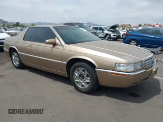 1999 Cadillac Eldorado ESC z VIN 1G6EL12Y5XU603764, wystawiony jako IAAI lot #42368692 z przebiegiem 154 613 mil mil oraz . Historia ofert i sprzedaży dostępna na DreamBid. Obrazek 1.