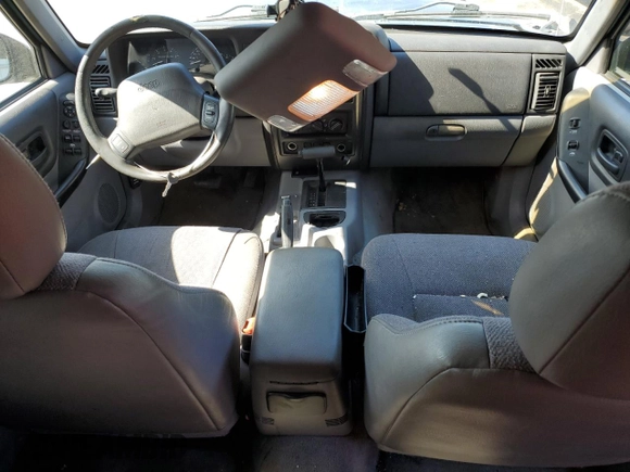 1998 Jeep Cherokee Sport with VIN 1J4FT68S4WL121559, listed as a Copart auction lot 77387794 with 163,453 mi miles and Salvage Title. Bid and sale history available at carsss.com. Image 8.