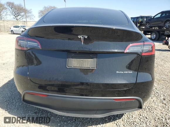 2023 Tesla Model Y Long Range with VIN 7SAYGAEE0PF642810, listed as a Copart auction lot 52181655 with 74,922 mi miles and Salvage Title. Bid and sale history available at DreamBid. Image 6.