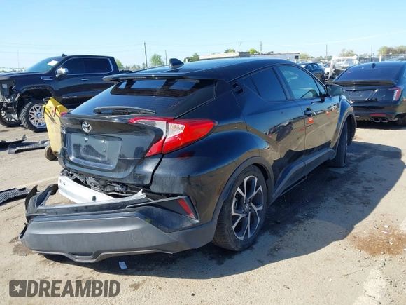 2020 Toyota C-HR LE with VIN JTNKHMBX9L1063563, listed as a IAAI auction lot 41986457 with 143,694 mi miles. Bid and sale history available at carsss.com. Image 4.