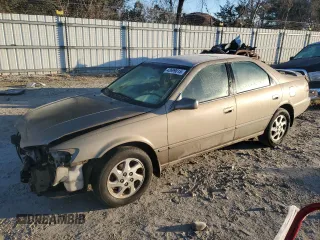 1999 Toyota Camry LE z VIN JT2BF22K0X0167589, wystawiony jako Copart lot #42699015 z przebiegiem 198 634 mil mil oraz Czysty tytuł • Clean title. Historia ofert i sprzedaży dostępna na DreamBid. Obrazek 1.