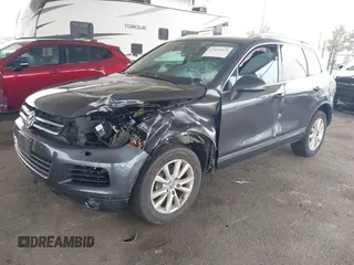 2014 Volkswagen Touareg Sport with VIN WVGEF9BP0ED015273, listed as a IAAI auction lot 42046823 with 84,694 mi miles and . Bid and sale history available at DreamBid. Image 2.