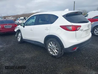 2015 Mazda CX-5 Grand Touring with VIN JM3KE4DY0F0483037, listed as a IAAI auction lot 41578222 with 102,988 mi miles. Bid and sale history available at carsss.com. Image 3.