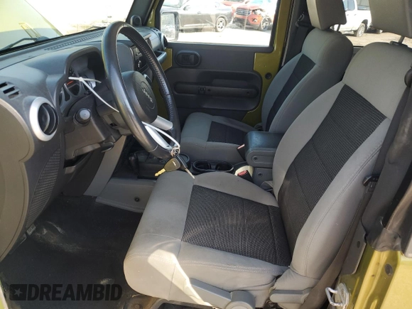 2010 Jeep Wrangler Sahara with VIN 1J4AA5D16AL203910, listed as a Copart auction lot 62891315 with 124,337 mi miles and Salvage title. Bid and sale history available at DreamBid. Image 7.