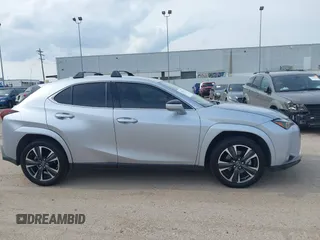 2023 Lexus UX 250h Premium z VIN JTHP6JBH5P2145912, wystawiony jako IAAI lot #42401353 z przebiegiem 14 252 mil mil oraz . Historia ofert i sprzedaży dostępna na DreamBid. Obrazek 13.