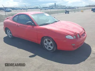 2001 Hyundai Tiburon z VIN KMHJG25F71U226180, wystawiony jako IAAI lot #42123872 z przebiegiem 167 444 mil mil oraz . Historia ofert i sprzedaży dostępna na DreamBid. Obrazek 1.