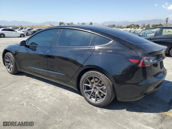 2021 Tesla Model 3 Standard Range Plus with VIN 5YJ3E1EAXMF069467, listed as a Copart auction lot 63273134 with 66,393 mi miles and Salvage Title. Bid and sale history available at carsss.com. Image 2.
