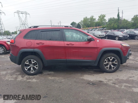 2015 Jeep Cherokee Trailhawk with VIN 1C4PJMBSXFW667469, listed as a IAAI auction lot 42438006 with 127,136 mi miles and . Bid and sale history available at DreamBid. Image 14.
