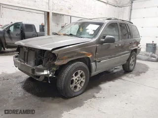1999 Jeep Grand Cherokee Laredo with VIN 1J4GW58SXXC584734, listed as a IAAI auction lot 41902224 with 209,180 mi miles. Bid and sale history available at carsss.com. Image 2.